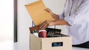 terminated employee putting work items in a box